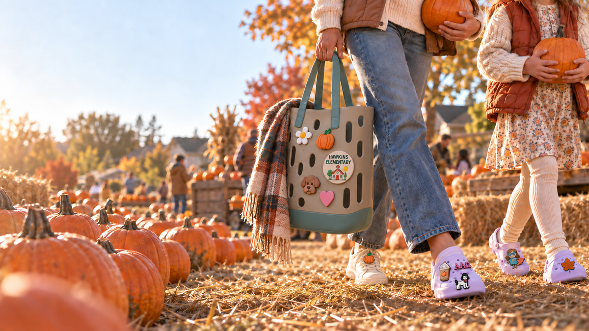 Adult and child choosing pumpkins at a suburban pumpkin patch while wearing Charmpatico charms
